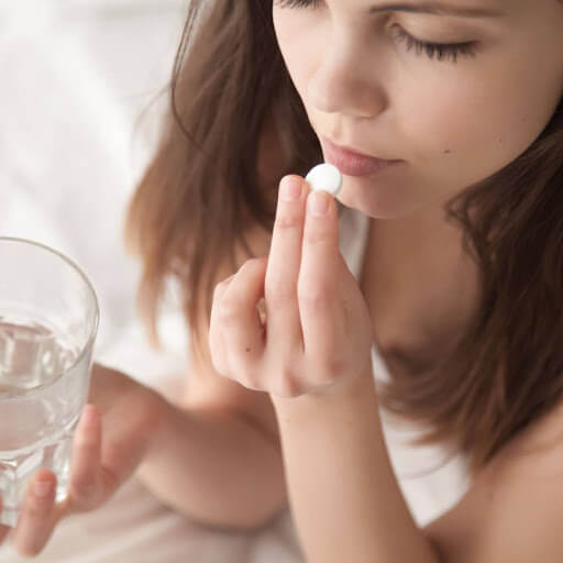 woman taking oral sedation pill